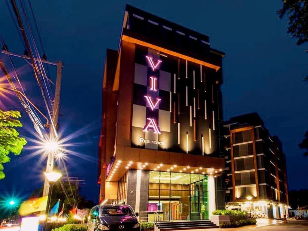 a building with a lit up sign on it at Viva Residence in Ban Baen Phichit