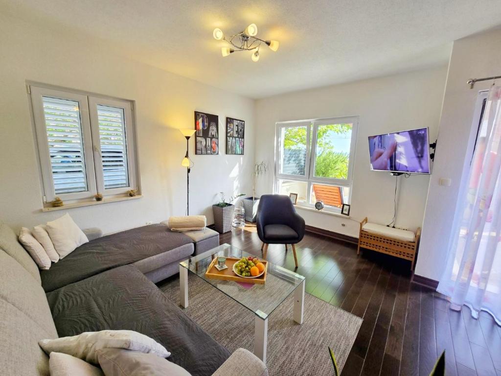 a living room with a couch and a table at Adria Apartment Makarska in Veliko Brdo