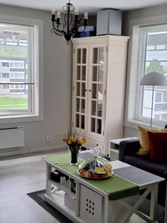 a living room with a table and a couch at Komfort in Lier