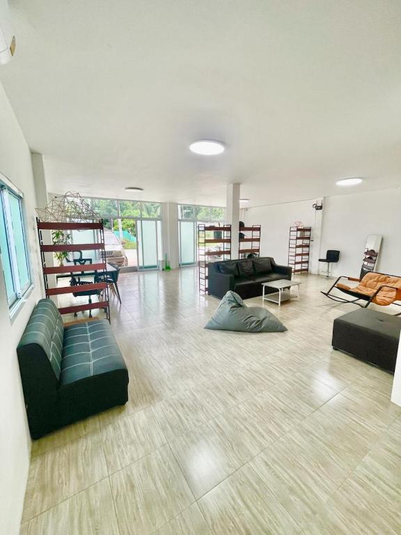 a large living room with couches and chairs in it at Unity coliving in Thong Sala
