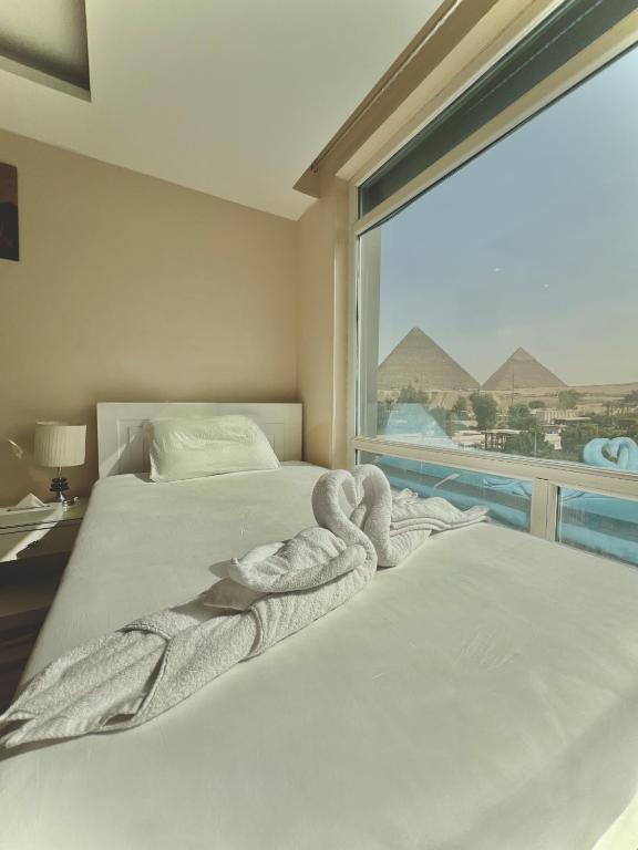 Postel nebo postele na pokoji v ubytování Turquoise Pyramids & Grand Egyptian museum view Hotel