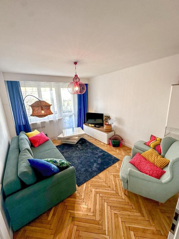 a living room with two couches and a television at Apartament przy Rynku in Sandomierz