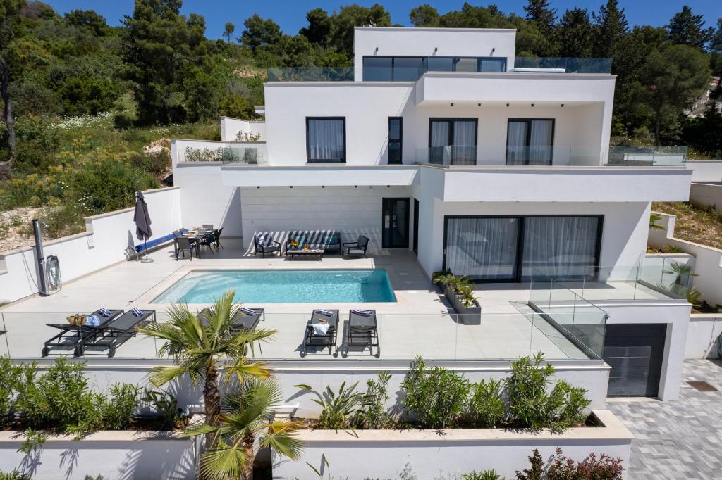an aerial view of a house with a swimming pool at Villa Oasis in Trogir