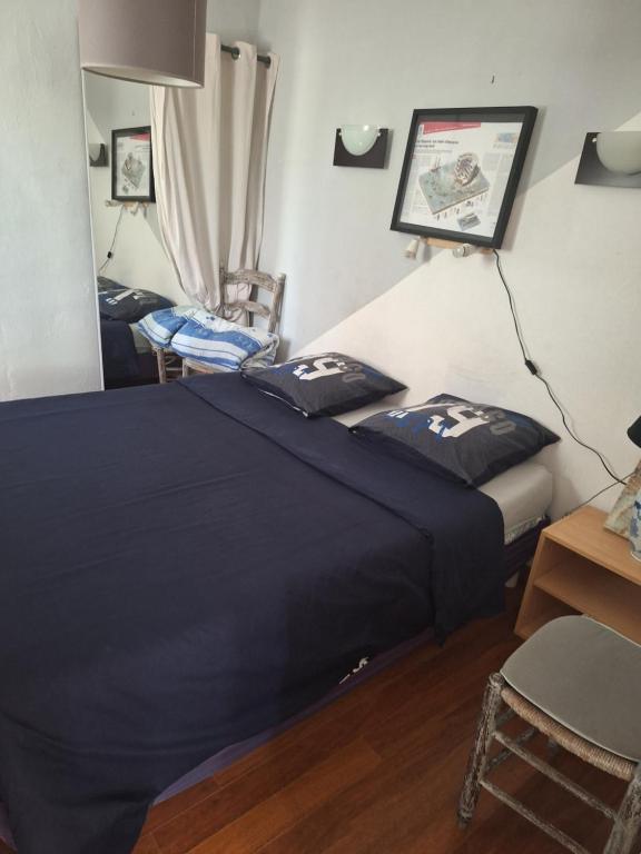 Una cama o camas en una habitación de petite maison 15 mn à pied du marche et vieux port