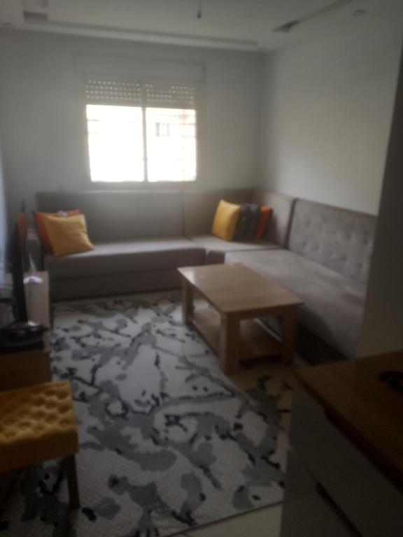 a living room with a couch and a coffee table at جوهرة البحر in Bel Aroussi