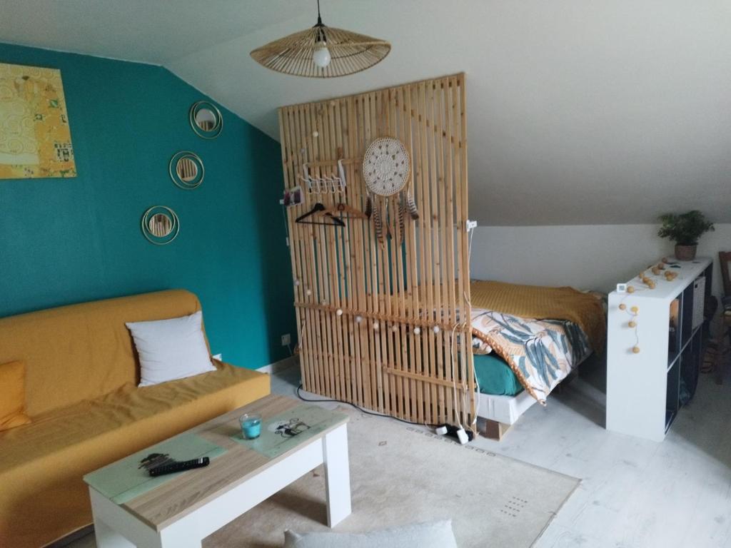 - un salon avec un canapé et une horloge murale dans l'établissement La chambre CHAT,au coeur des Vosges, à Ferdrupt