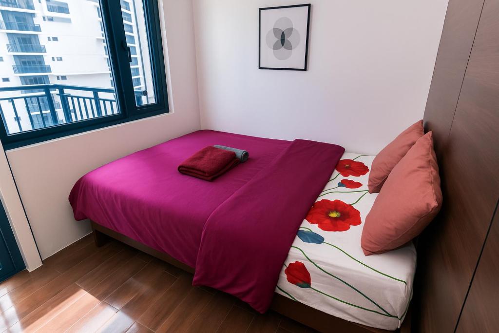 a small bedroom with a bed with a purple blanket at Suite Life Makati Vibes Views Relaxation 3870 in Manila