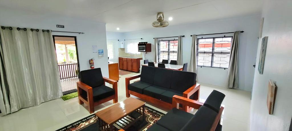 a living room with two chairs and a table at Favored Haven in Sarava