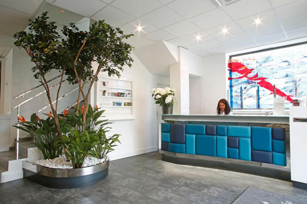 a room with a counter with plants in it at Hôtel Méditerranée in Calvi