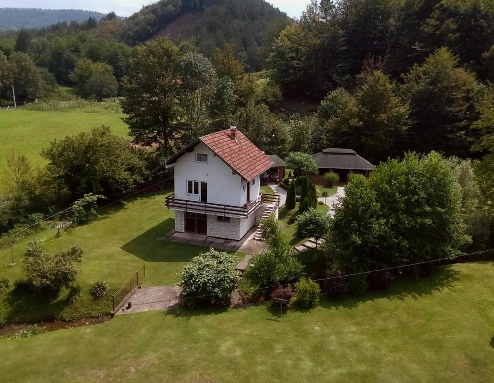 an aerial view of a house in a field at Vikendica Niki - Village house with pool in Ćetojevići