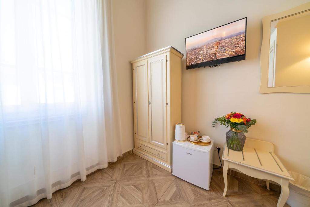 a small room with a white cabinet and a table at Residenza Conte di Cavour & Rooftop in Florence