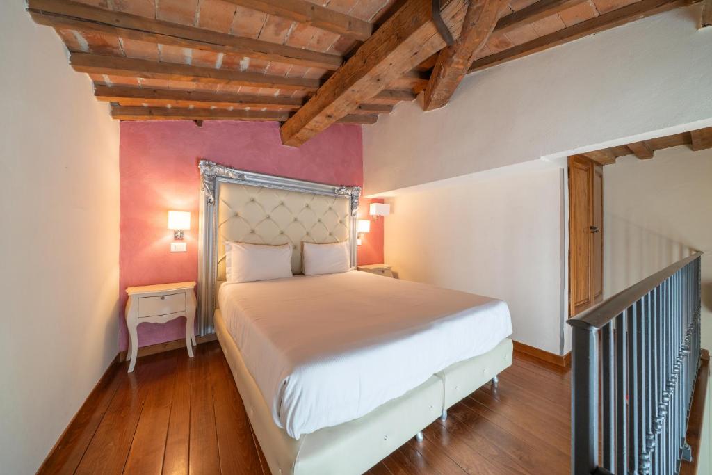 a bedroom with a large bed in a room at Residenza Conte di Cavour & Rooftop in Florence