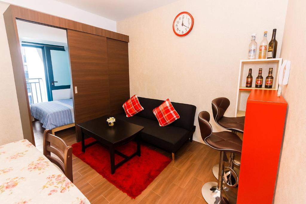 a small living room with a table and a bed at Velvet Vibe Chic Makati Stay Pool Gym 4034 in Manila