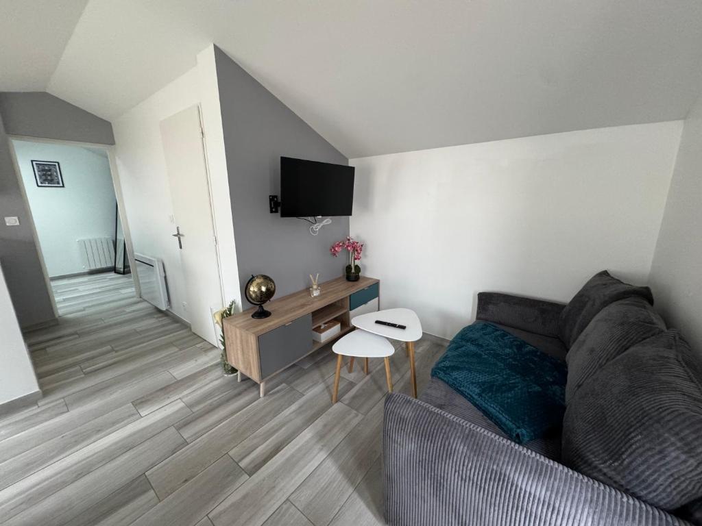 un salon avec un canapé et une table dans l'établissement Maisonnette indépendante, à Chaumont