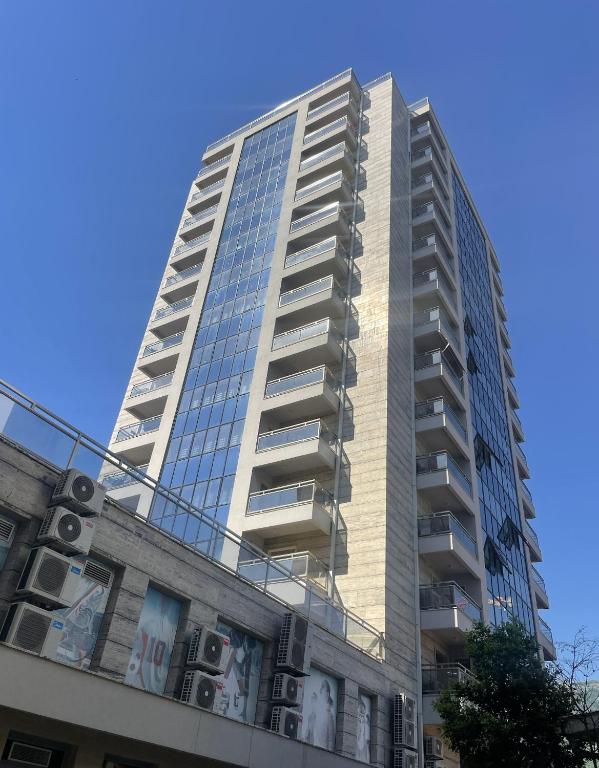 a tall building with windows on top of a building at DimaX Apartments in Budva
