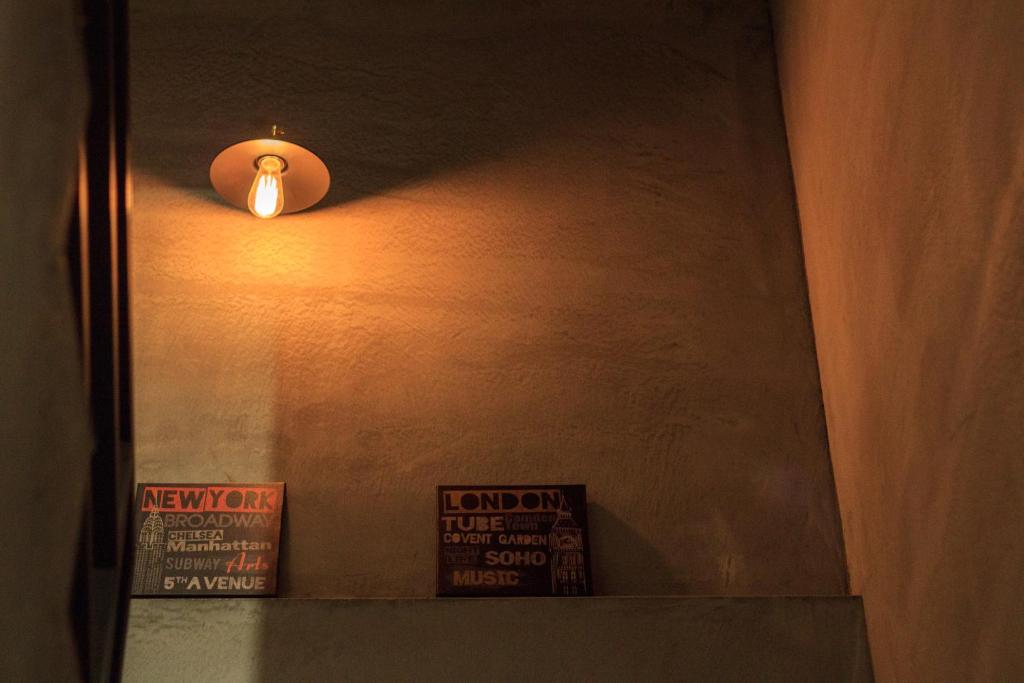 a light on a wall with a sign on a shelf at Book 5 in Dongshan