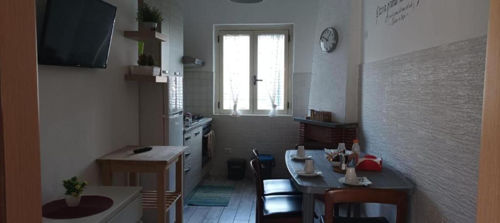 a kitchen with a table and a dining room at Marechiaro in Sapri