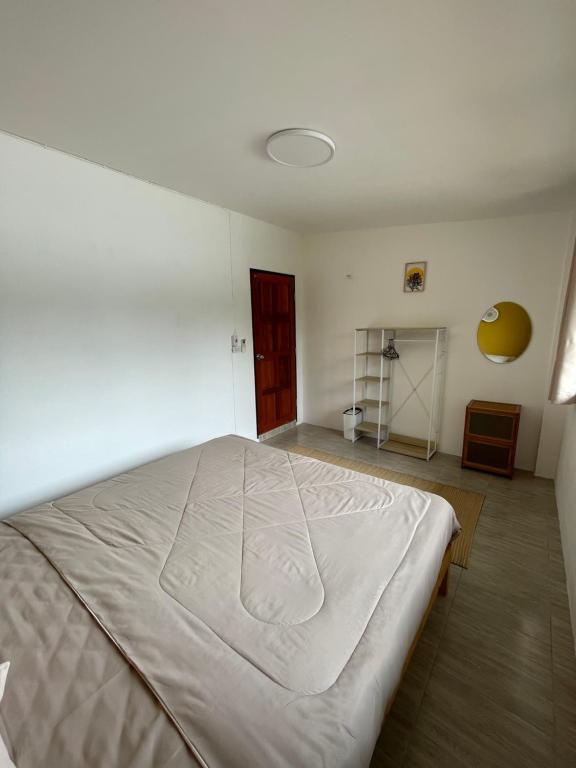 a bedroom with a large white bed in a room at Unity coliving in Thong Sala