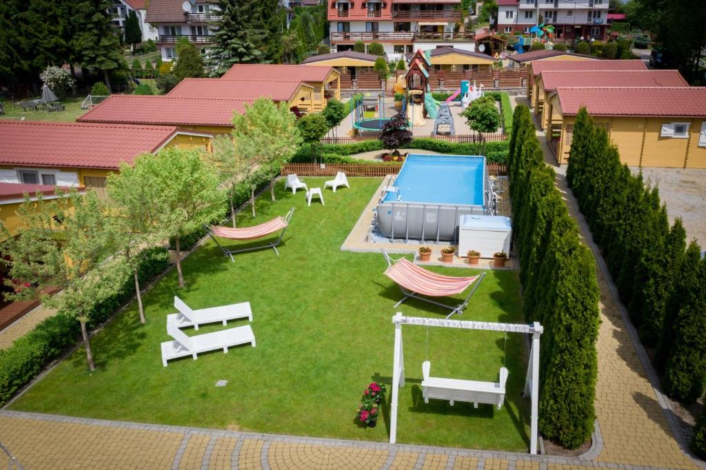 an aerial view of a backyard with a pool at Stacja Lato domki dla rodzin z dziećmi in Mikołajki