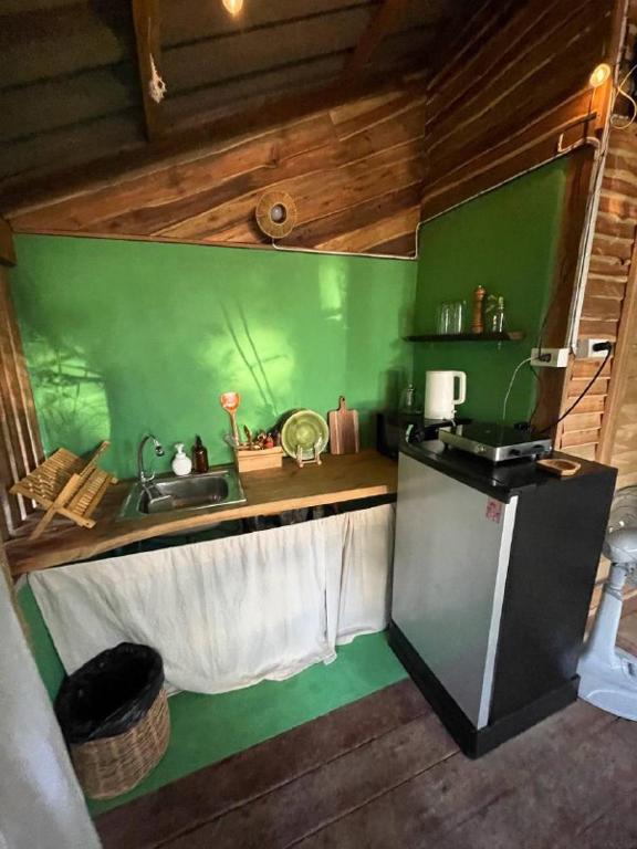 a green kitchen with a sink and a counter at Unity coliving in Thong Sala