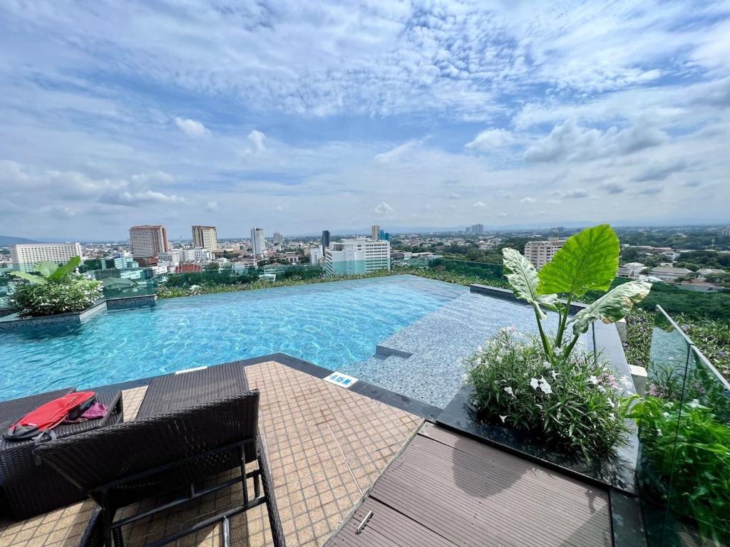 a swimming pool on top of a building at Grand 2-Bedroom Condo with Pool in Chiang Mai