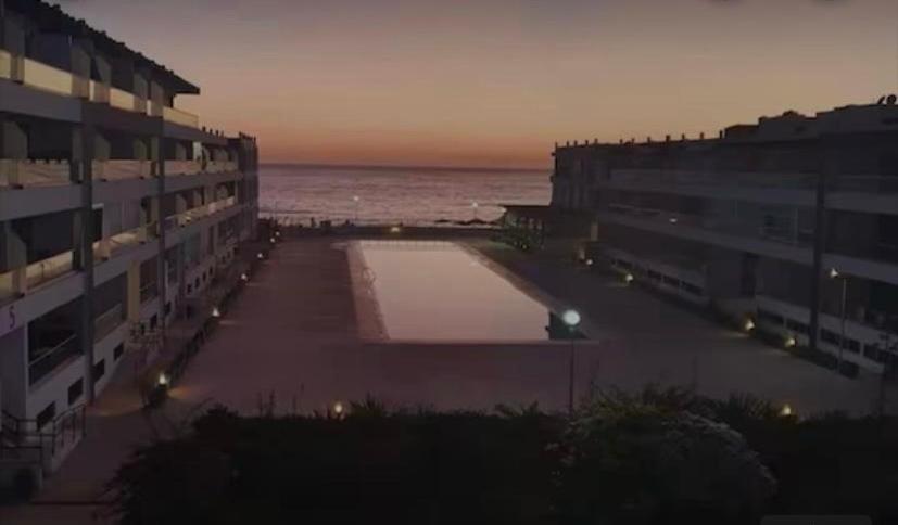 阿加迪尔Adan Beach Apartment的享有大楼和日落海景