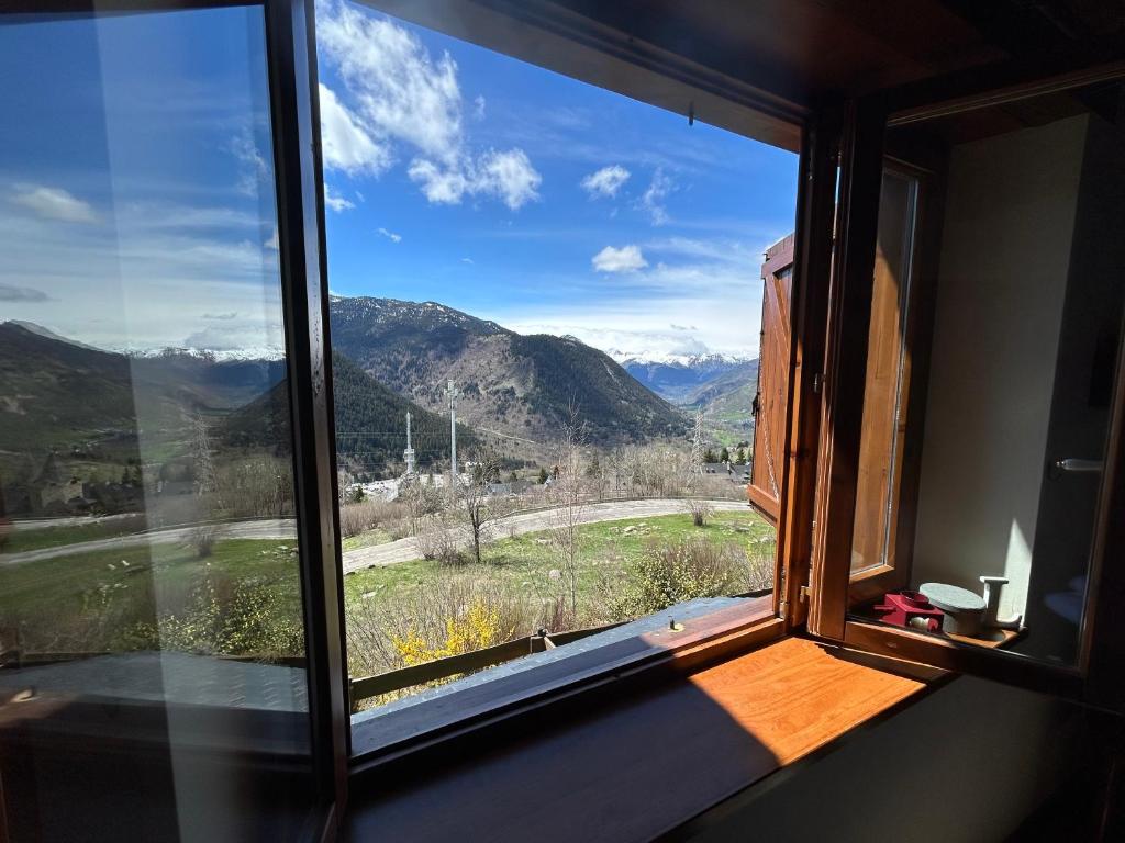 a window with a view of a mountain view at Casa Baqueira Beret en Pleta de Nheu Cota 1700 in Baqueira-Beret