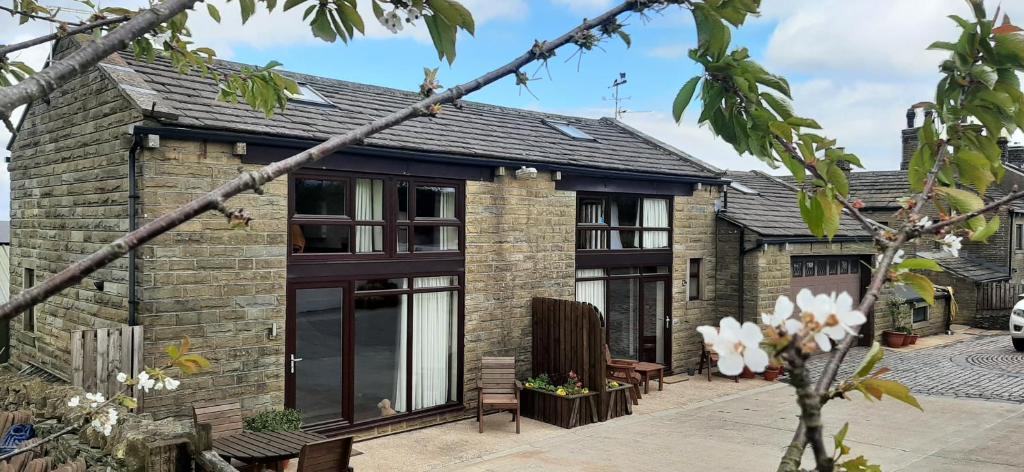 a brick house with black windows and a roof at South view farm cottage 2 Bed in Thornton