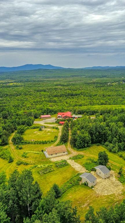 an aerial view of a farm with houses and trees at 201 Cabins in Jackman