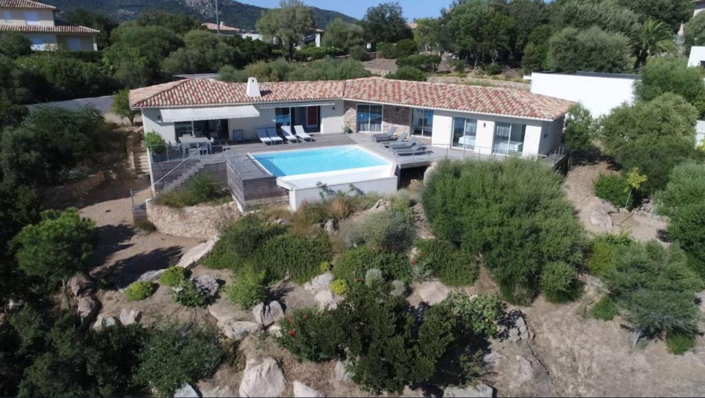 an aerial view of a house with a swimming pool at Padulaccia by Pinarello Villa Services in Pinarellu