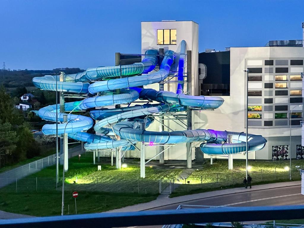 a blue water slide in front of a building at Apartment 19 - Aquapark Reda in Reda