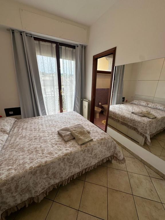 Un dormitorio con una cama y un espejo grande. en Golden Lungarno River, en Florencia