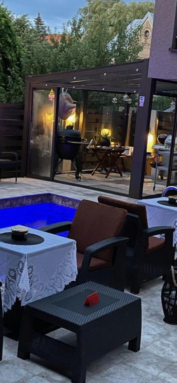 a backyard with a pool with a table and chairs at Palanga Classic White Studio in Palanga
