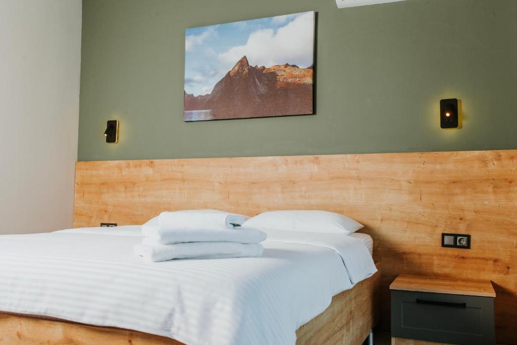 a bedroom with a bed with towels on it at Golyaka Stone Garden Hotel in Orhangazi