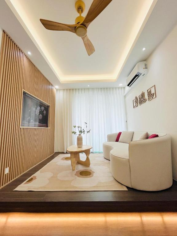 a living room with a ceiling fan and a couch at Vista Bangi Muji-styled 3BR Sunrise view in Kajang