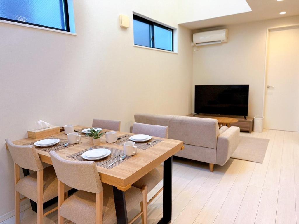 a dining room with a table and a couch at Tabi in Tokyo in Tokyo