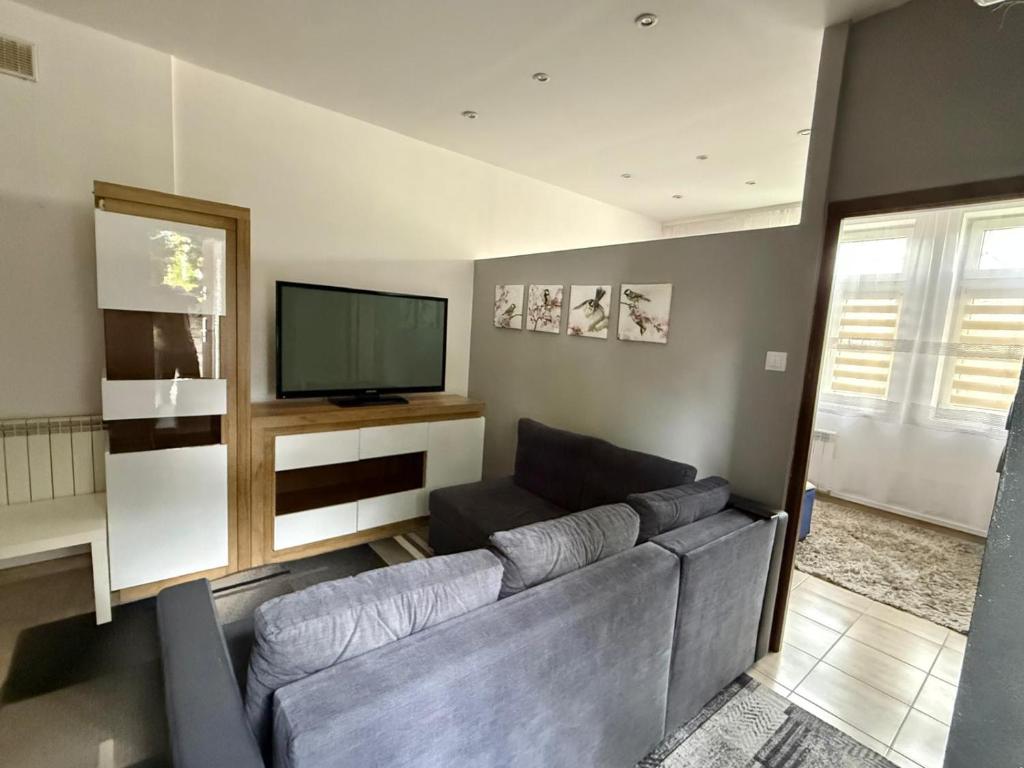 a living room with a couch and a flat screen tv at Apartament Ząbki in Ząbki