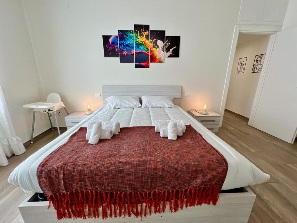 a bedroom with a large bed with two towels at 25 minutes MILANO DUOMO Elegant Apartment Center Sesto in Sesto San Giovanni