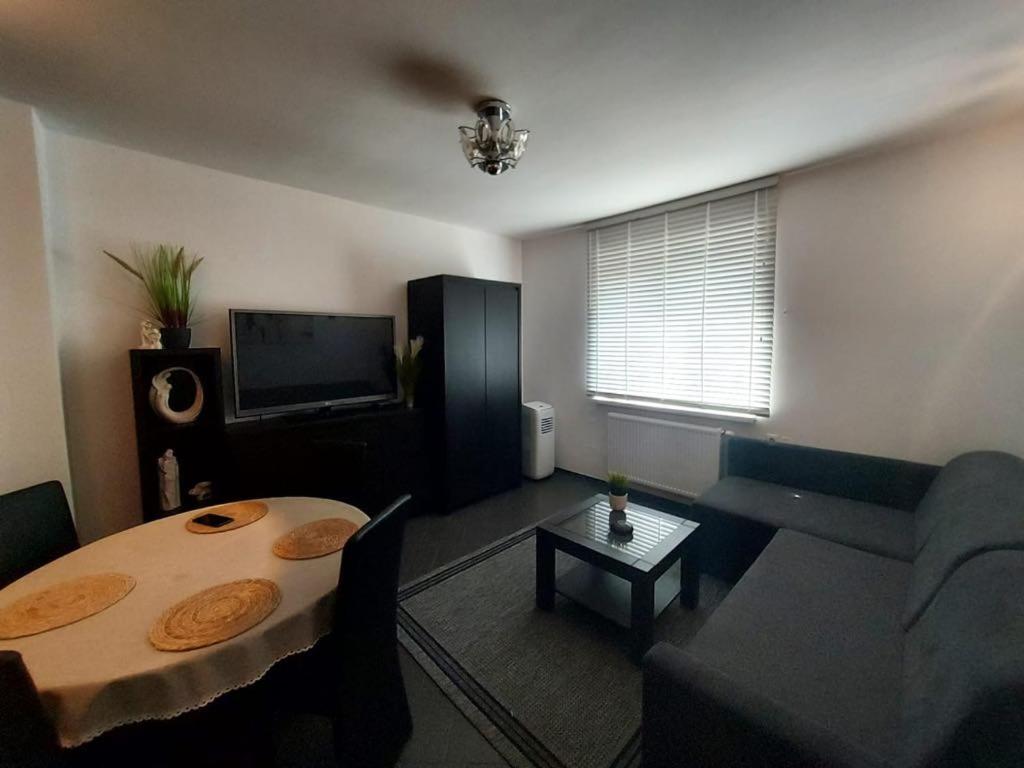 a living room with a table and a couch at AuroraBoguszow in Boguszów-Gorce
