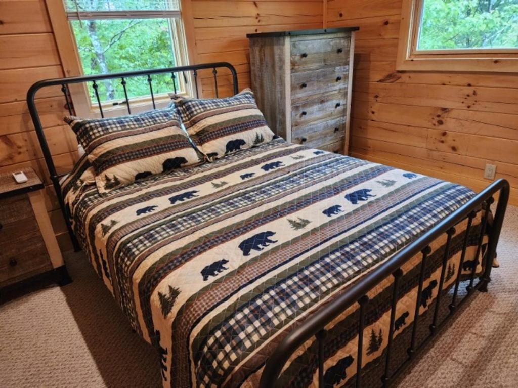 a bedroom with a bed in a log cabin at Three bears lodge in Gatlinburg
