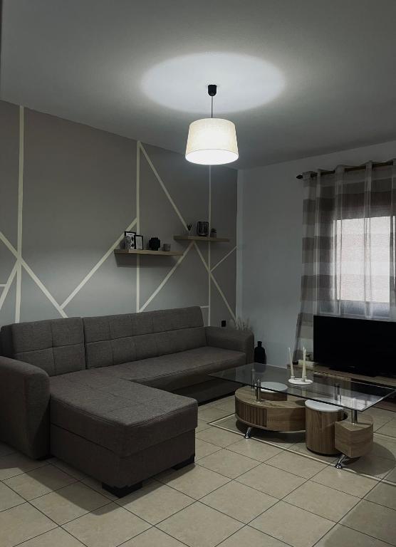 a living room with a couch and a table at Elena House in Nea Peramos