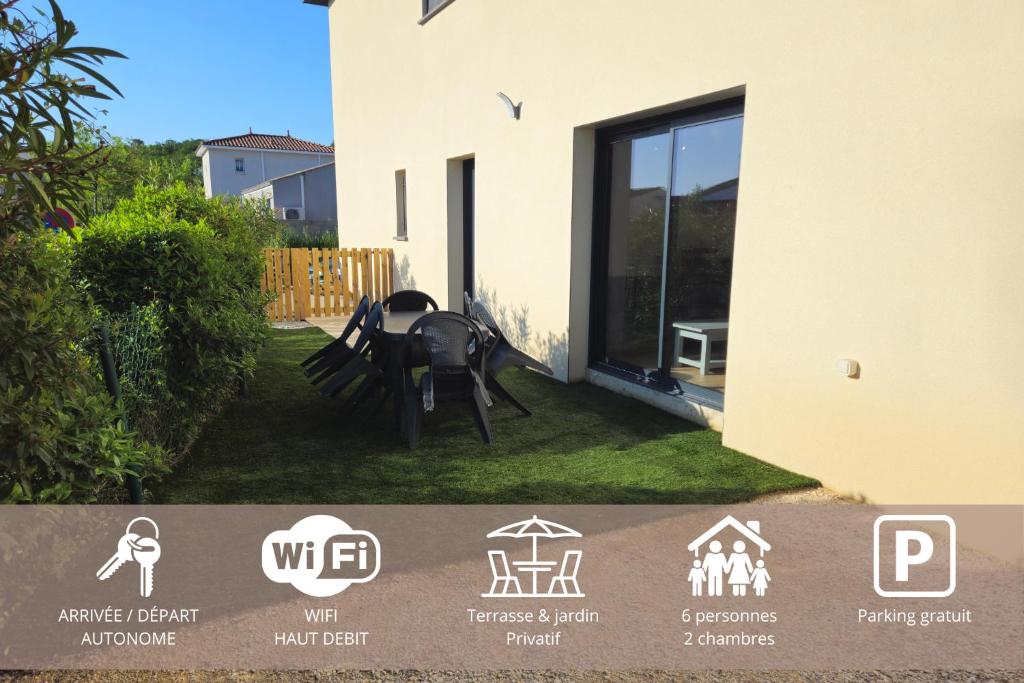 a house with a table and chairs in the yard at Villa des Moulins in Gabian