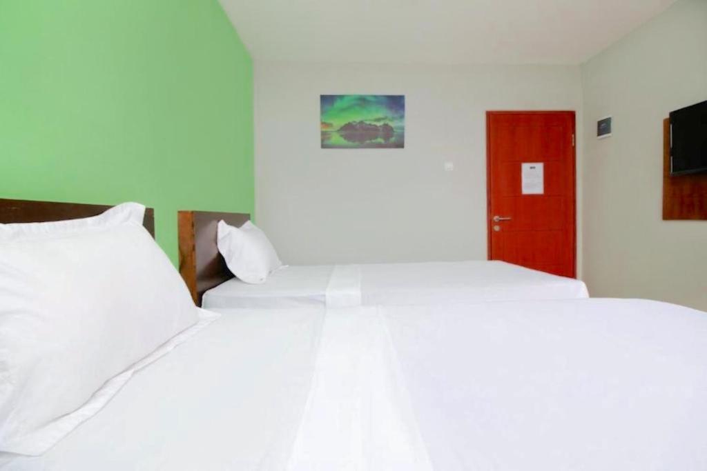 Letto o letti in una camera di The Aurora by Makati