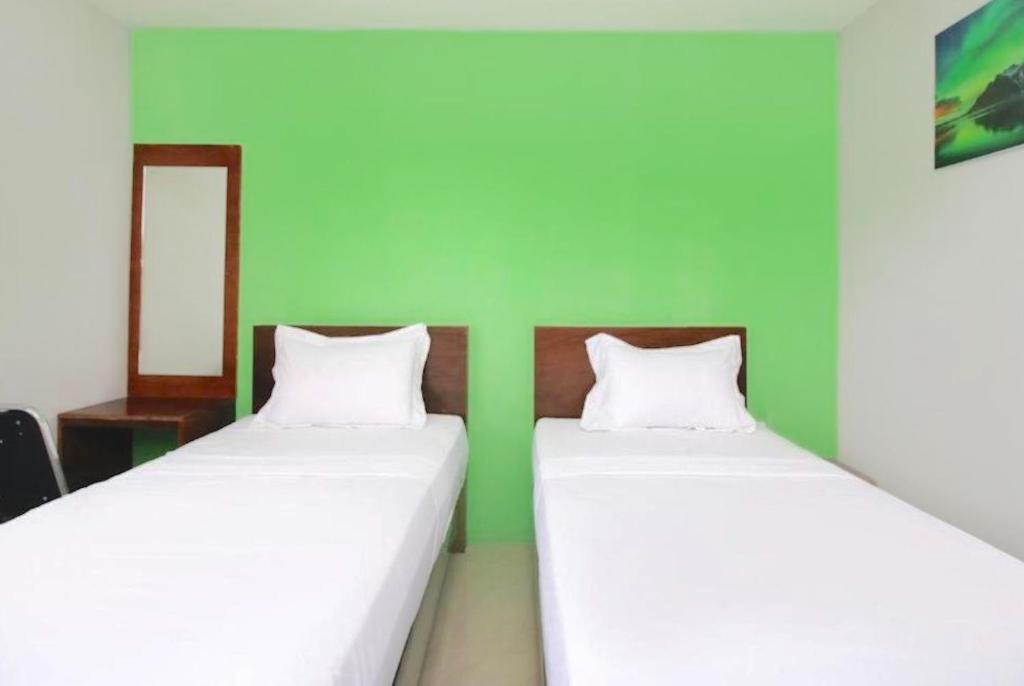 Letto o letti in una camera di The Aurora by Makati