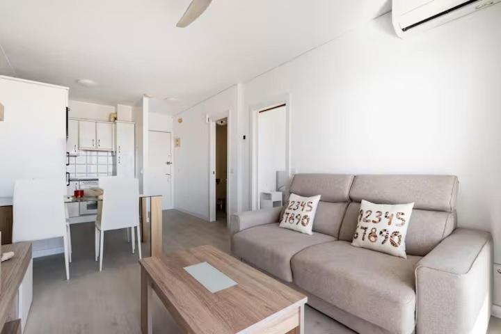 a living room with a couch and a table at RentitSpain - Nerja - Apartamentos Vistas Únicas al Mar Mediterráneo in Nerja