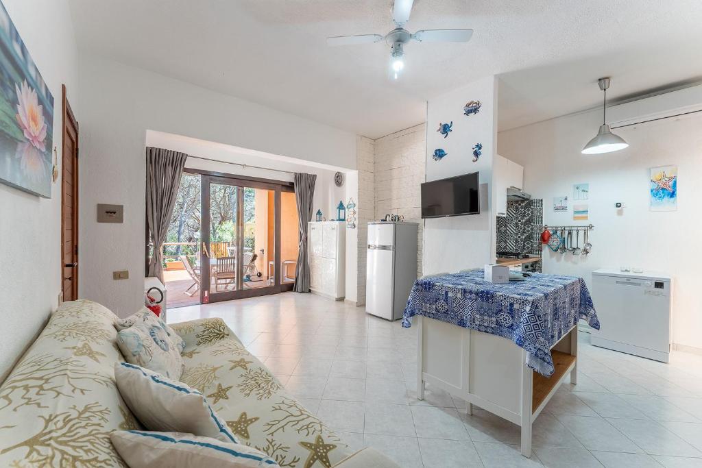 a kitchen and living room with a couch and a table at Casa Mimose, 200m to beach in Pula