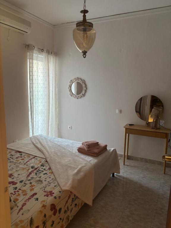 a bedroom with a bed and a mirror on the wall at Haus Rosi in Rhodes Town