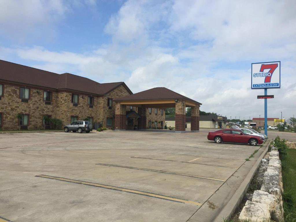 a building with a car parked in a parking lot at Studio 7 Harker Heights in Harker Heights