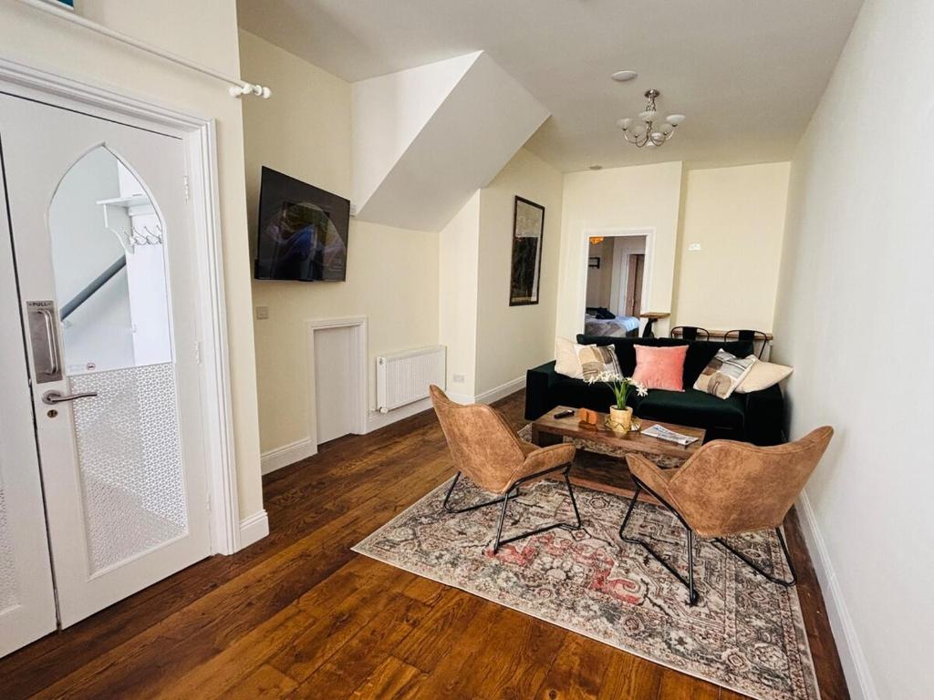a living room with a table and chairs and a couch at Twenty 7 - Modern & Spacious Townhouse in Killaloe