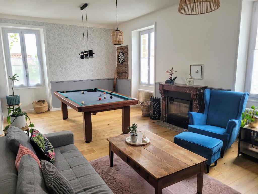 a living room with a pool table and blue chairs at Hellfest 2025 chambre petit-déjeuner in La Celle-sous-Gouzon